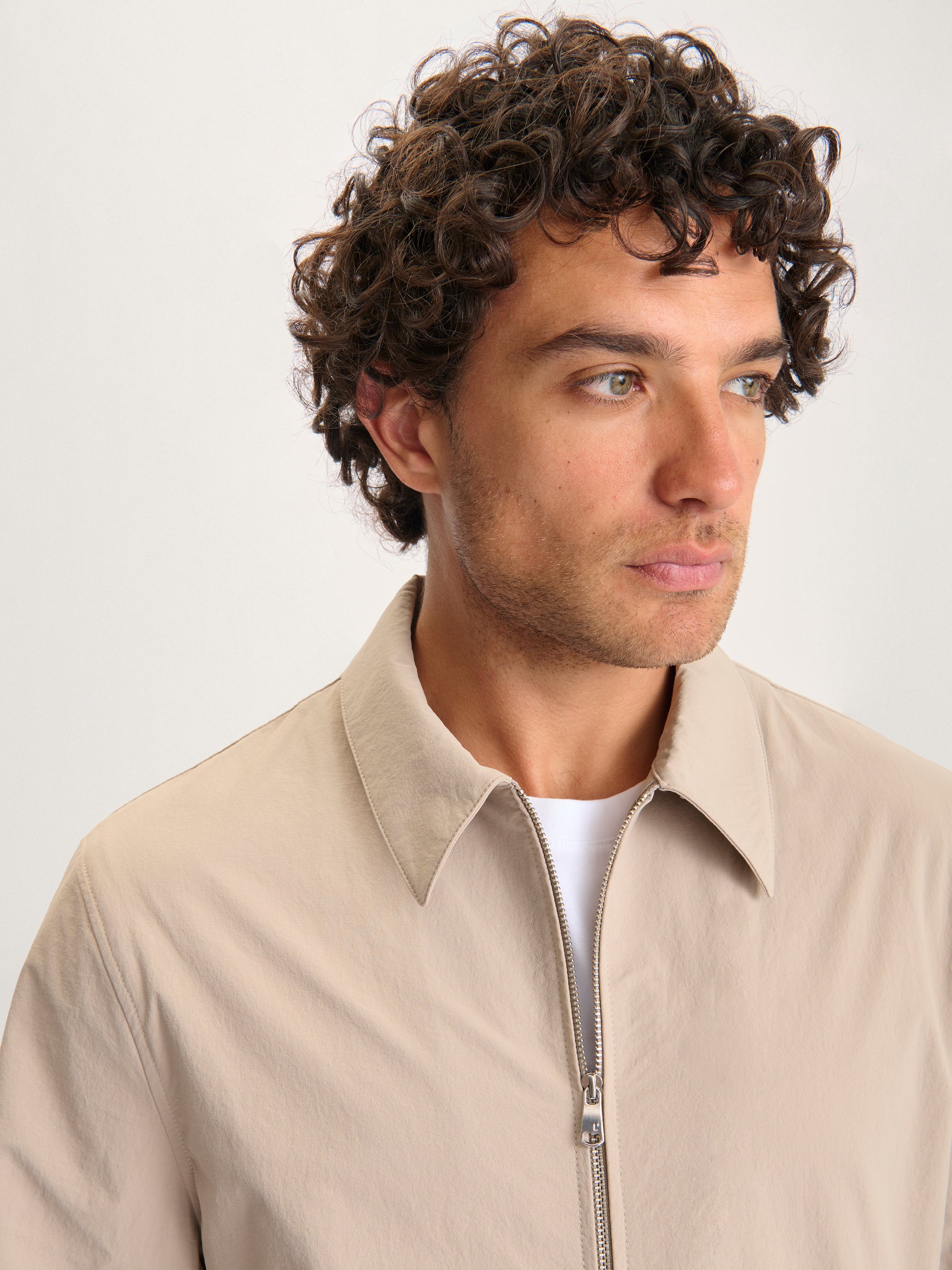 Close-up of the Lestrange London 360 Jacket in beige showing collar and zip details