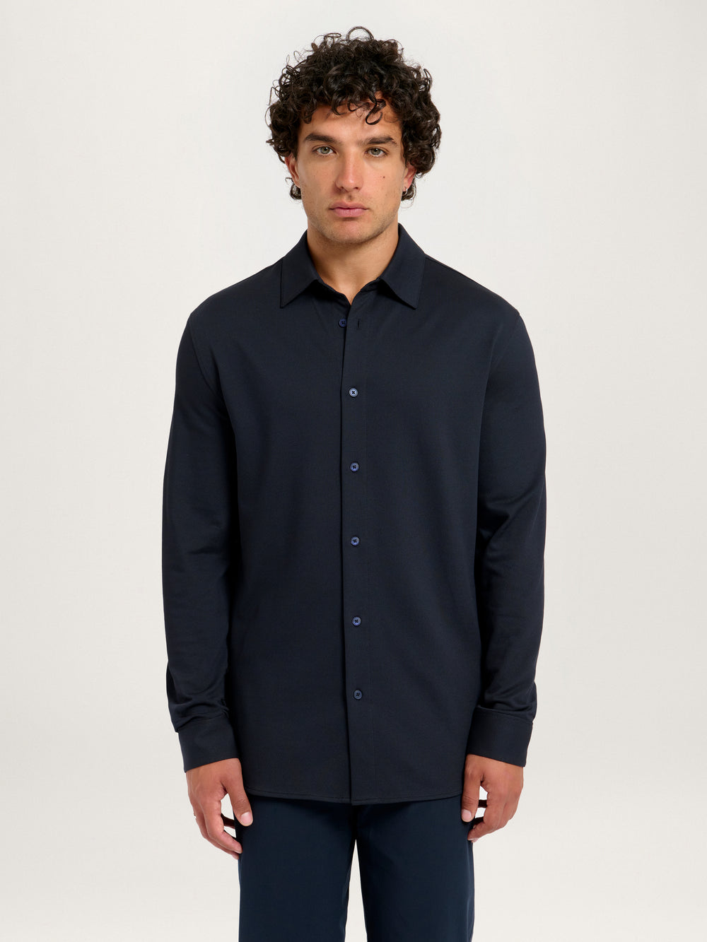 Model front view wearing Lestrange London 360 Mesh Tech Shirt in navy, size medium, height 183 cm