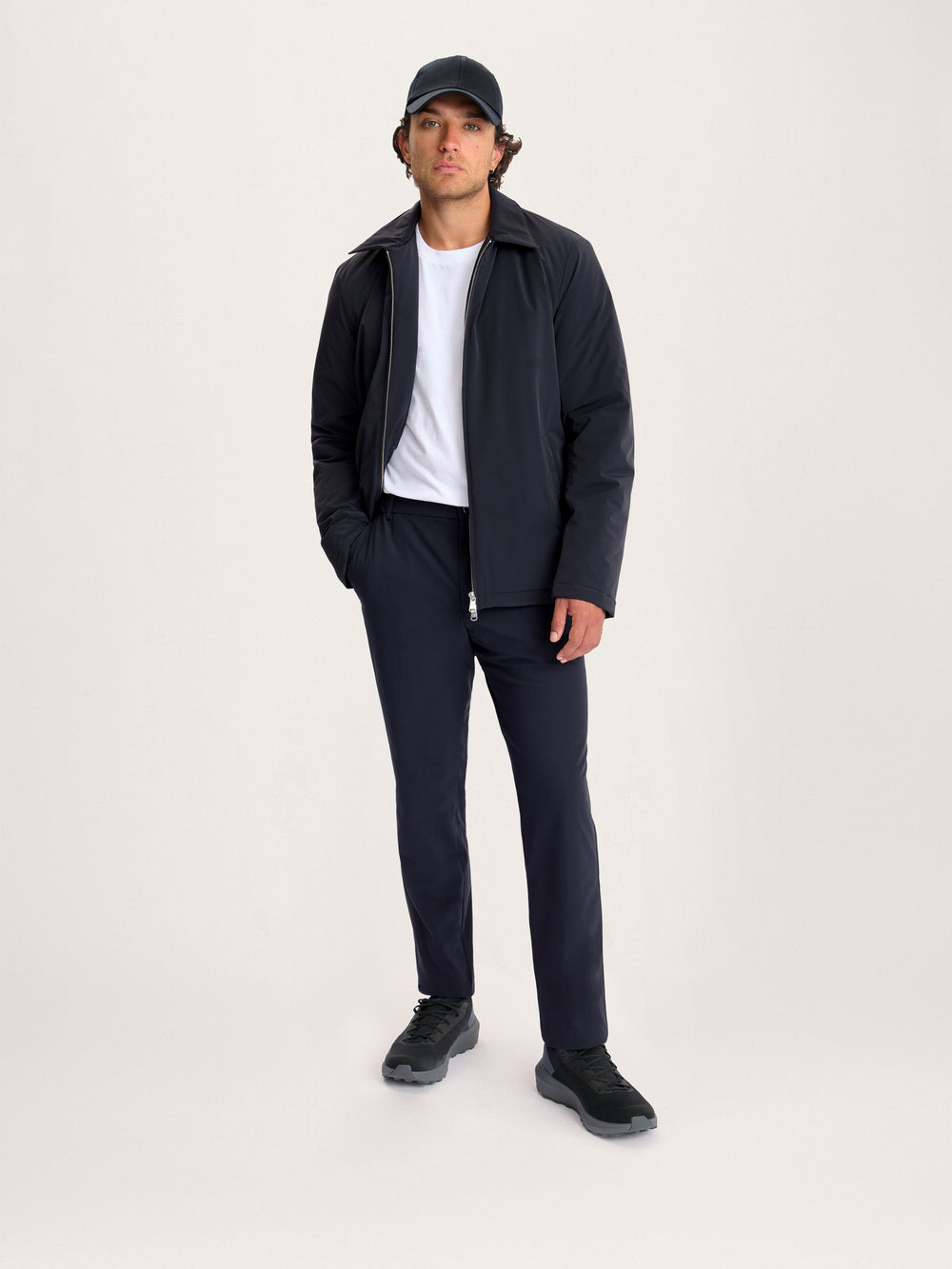 Full body view of model in Lestrange 360 Thermal Jacket navy, styled with matching trousers and sneakers for modern menswear look