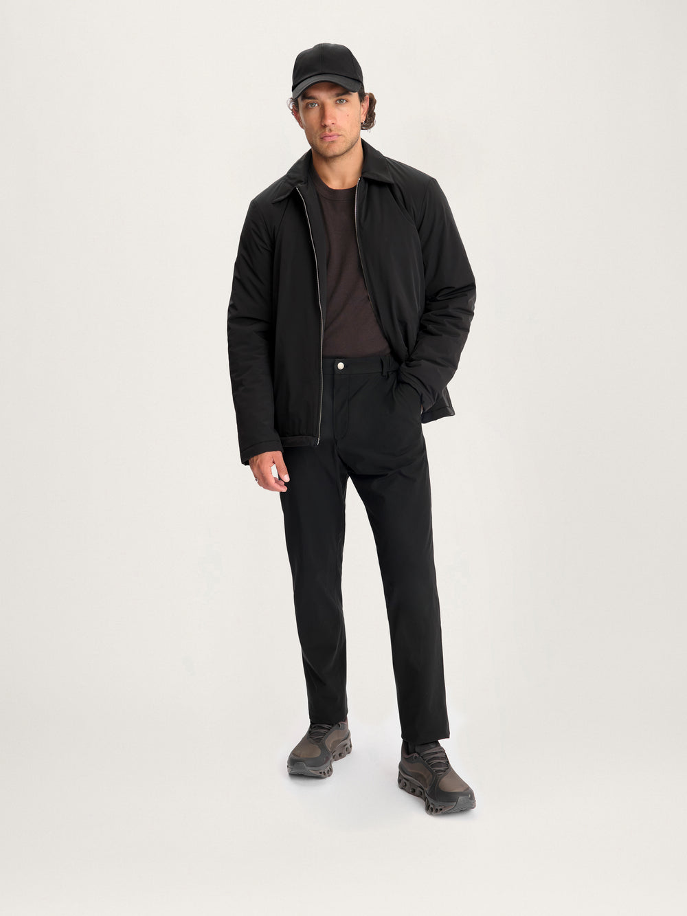 Model wearing Lestrange 360 Thermal Jacket in black, styled with black trousers, dark sneakers, and a minimalist casual look
