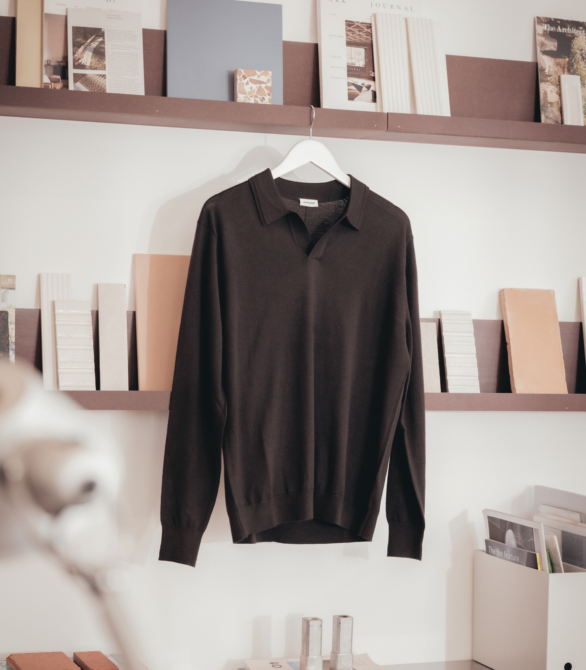 Lestrange espresso long sleeve polo shirt on hanger, displayed in contemporary interior setting