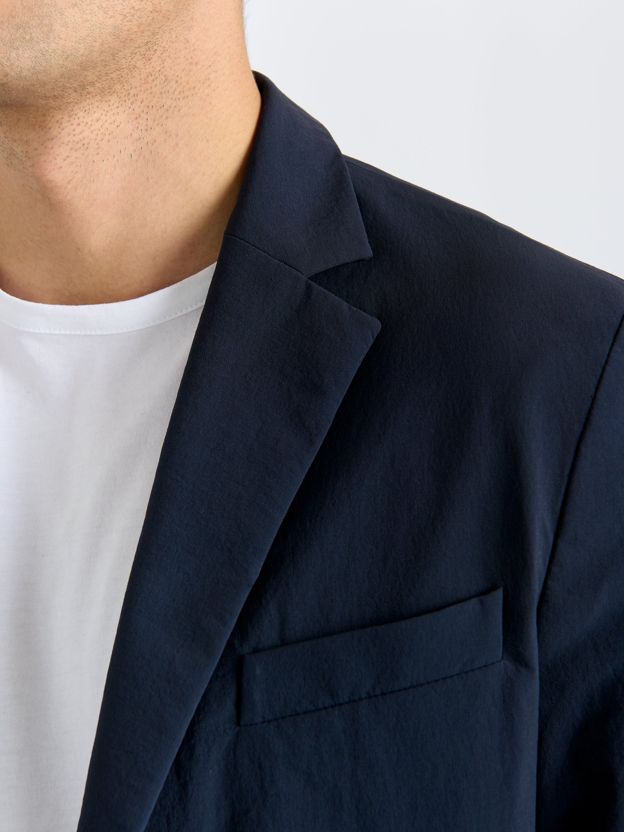 Close-up of Lestrange 360 Blazer in navy highlighting the sharp lapel and chest pocket detail.