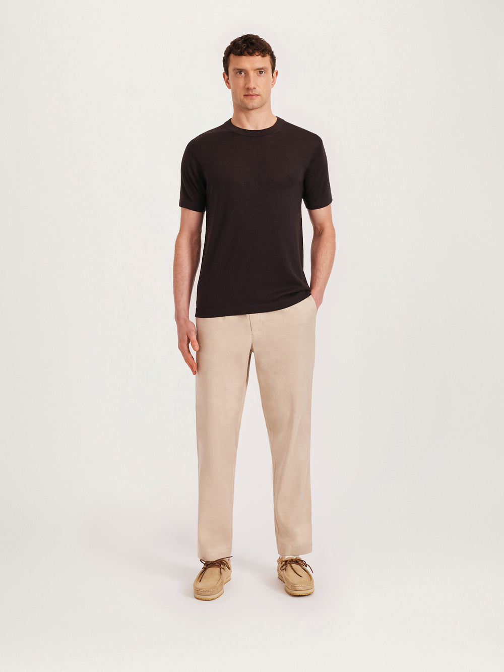 Men’s coffee brown knitted T-shirt styled with beige trousers and suede shoes – Lestrange London