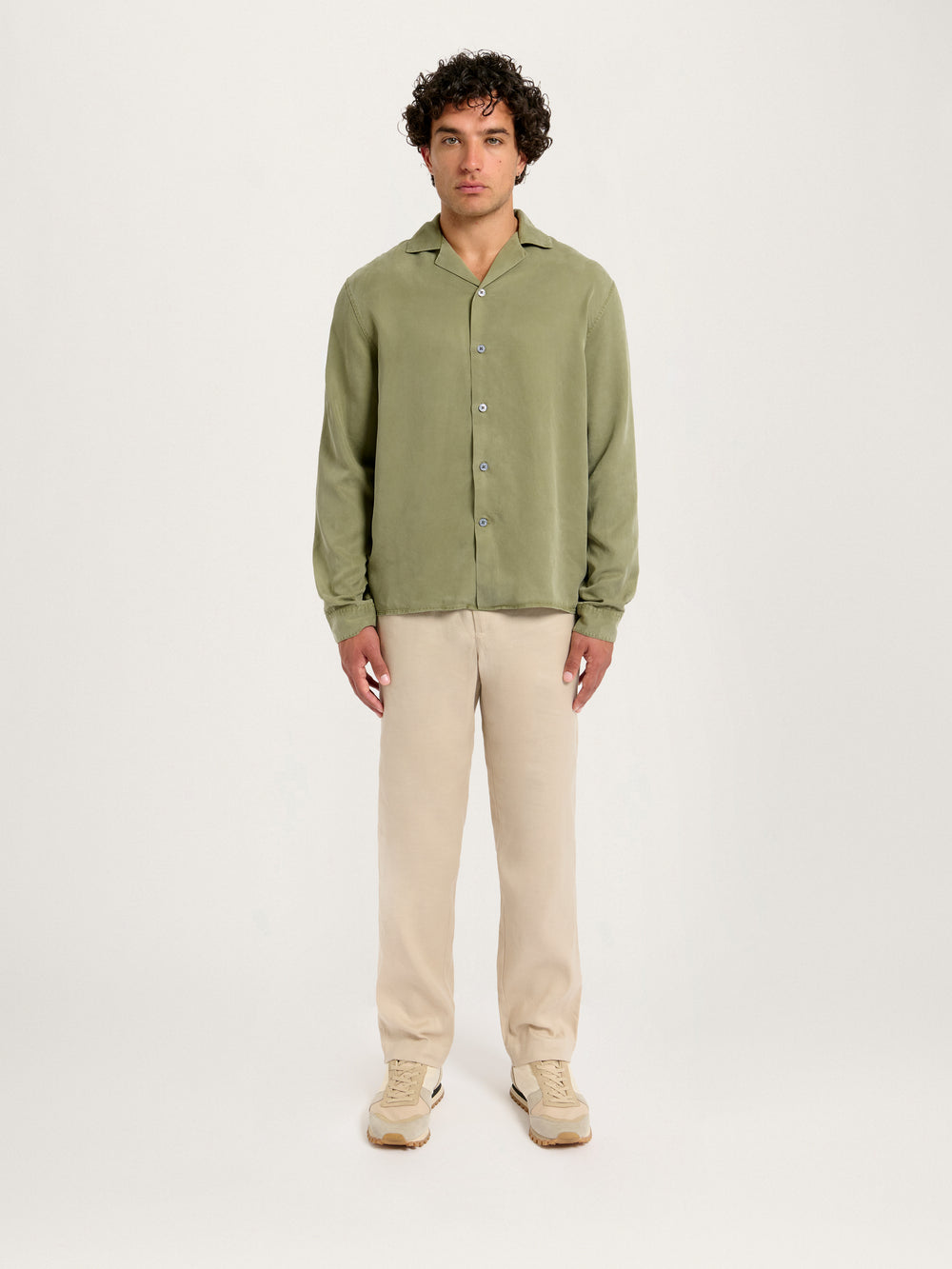 Model wearing Lestrange London Cuban Collar Tencel Shirt Khaki with beige trousers – full front view