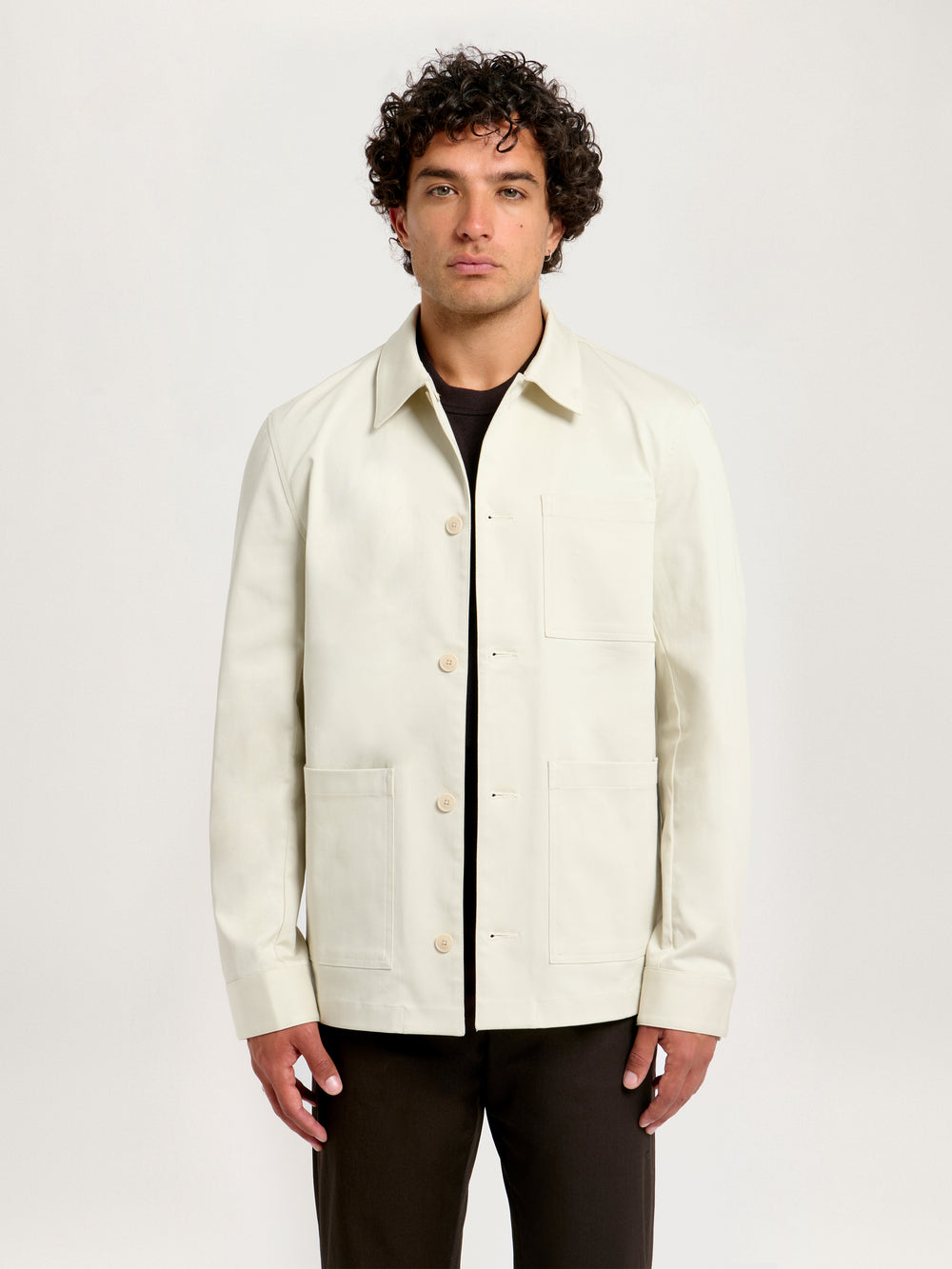 Men’s Utility Jacket in Flint – Front view with button closure, styled with brown trousers
