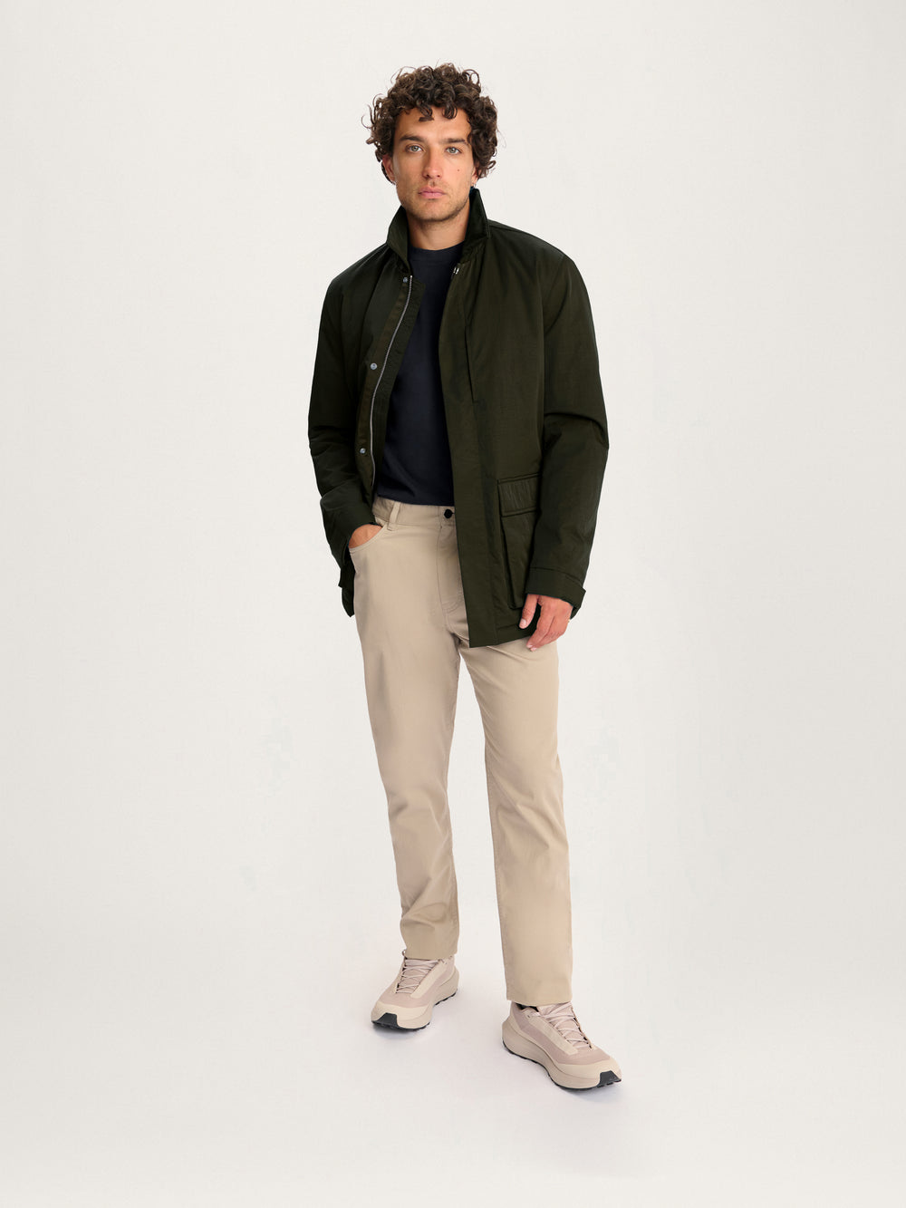 Men’s Lestrange Field Jacket in olive green styled with beige trousers – full outfit view.