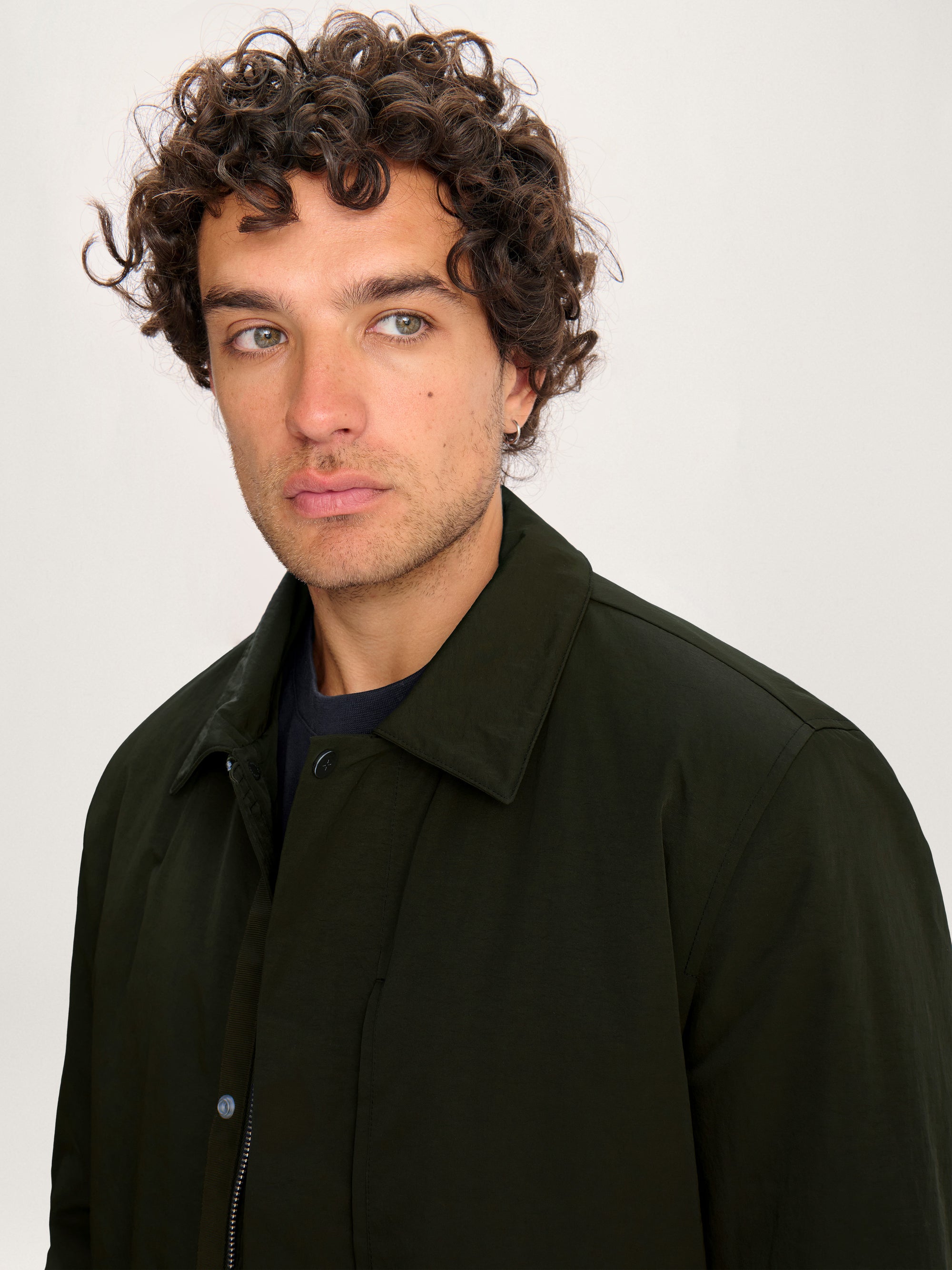 Close-up of the Lestrange olive green Field Jacket collar and fabric texture.