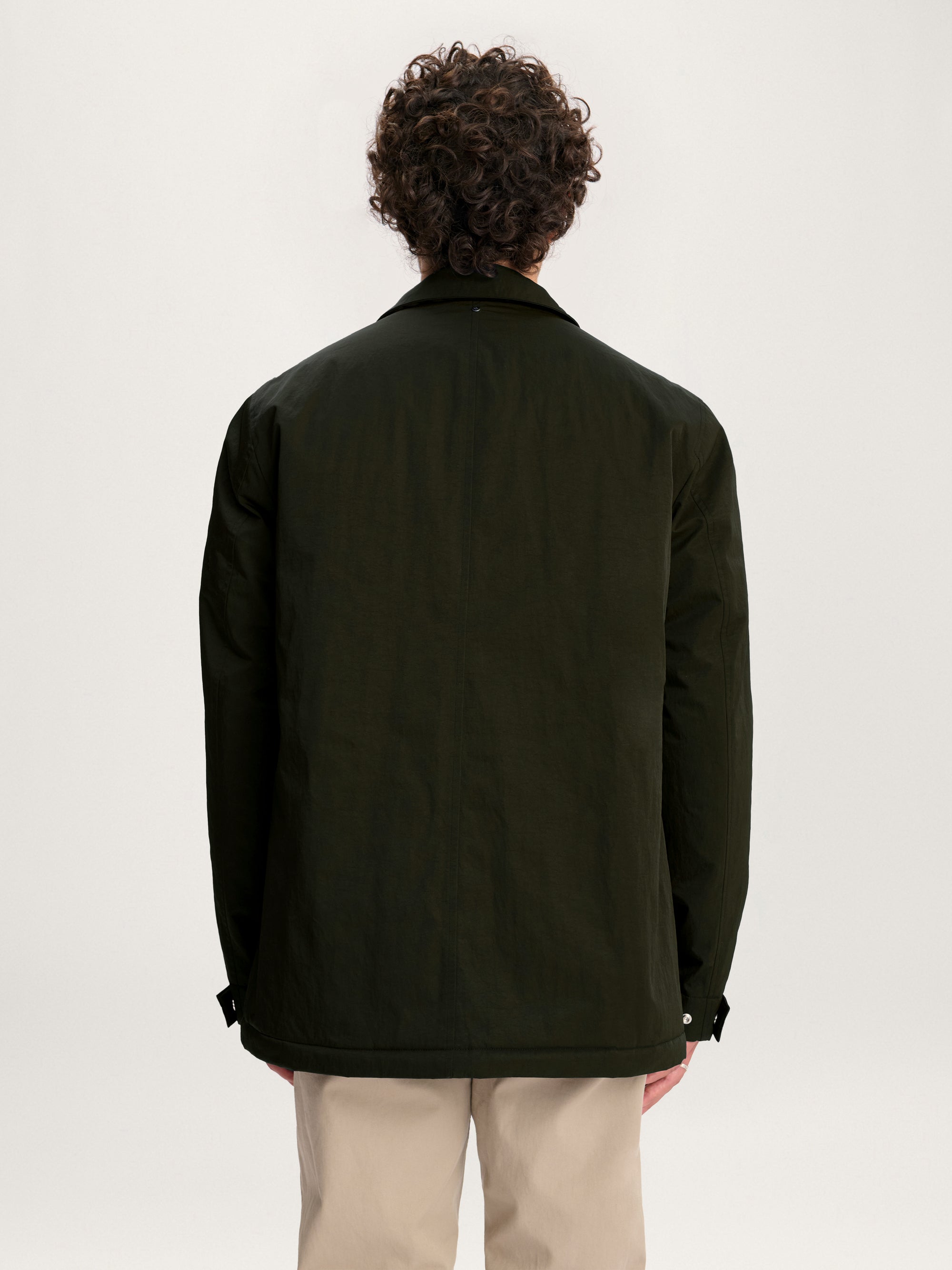Back view of the men’s Lestrange Field Jacket in olive green showing clean seam and relaxed fit.