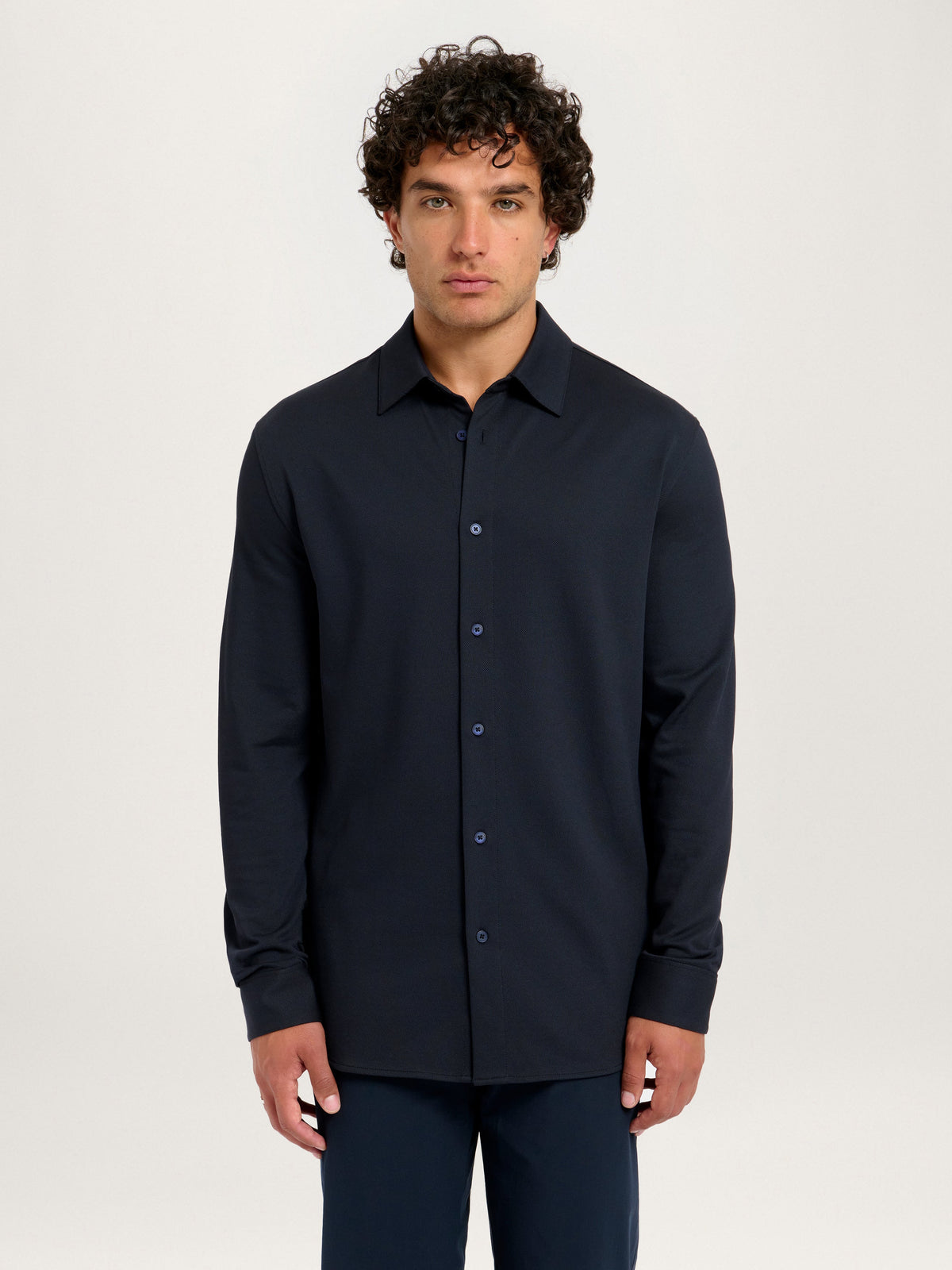 Model front view wearing Lestrange London 360° Pique Shirt in navy, size medium, height 183 cm