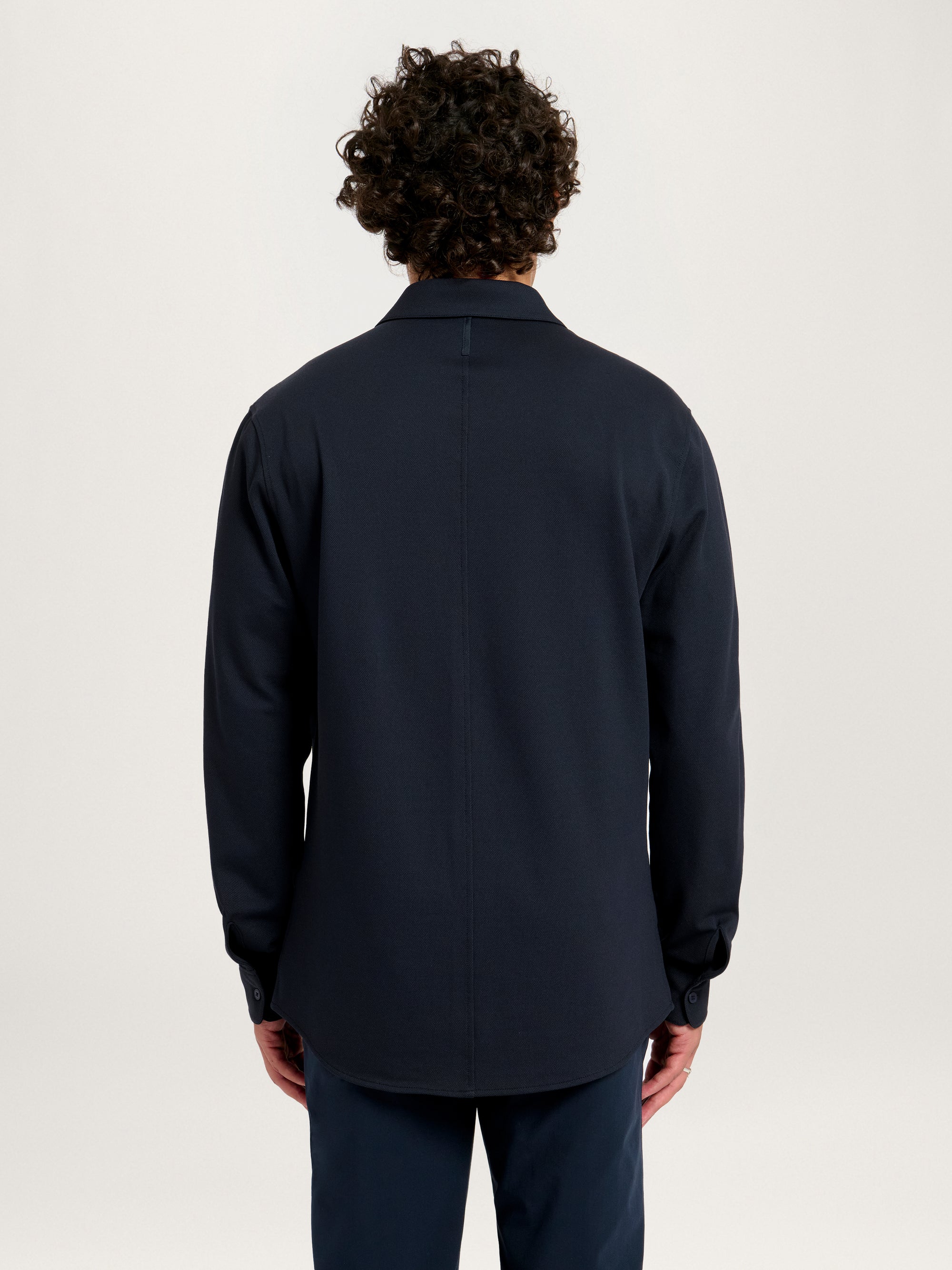 Back view of Lestrange London 360 Mesh Tech Shirt in navy, showing clean seam and curved hem