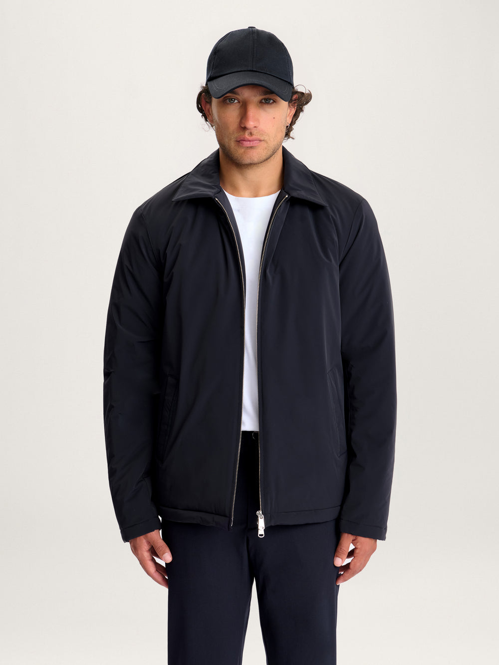 Man wearing Lestrange 360 Thermal Jacket in navy, minimalist insulated jacket with zip closure and pointed collar