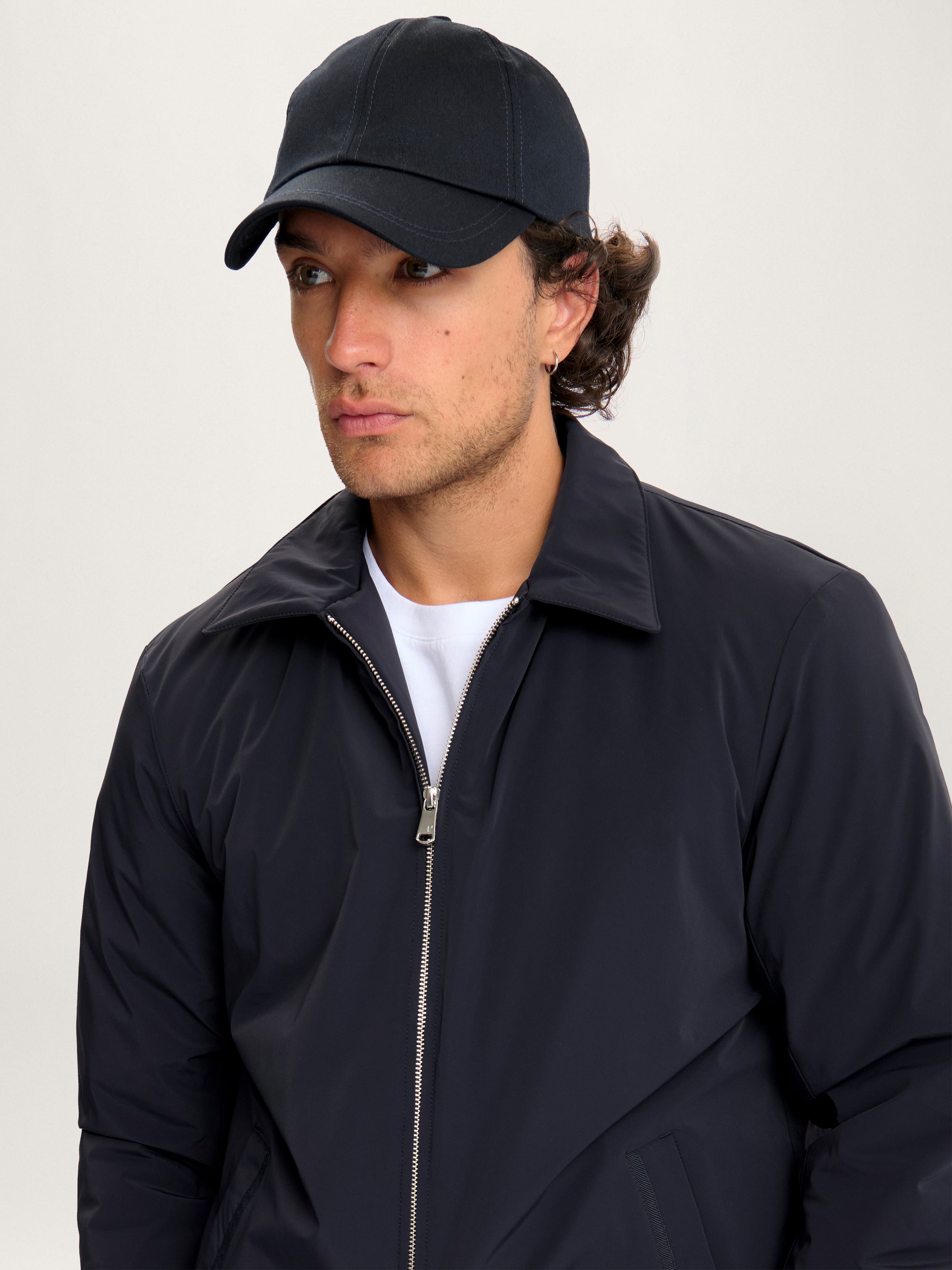 Man wearing Lestrange 360 Thermal Jacket in navy, minimalist insulated jacket with zip closure and pointed collar