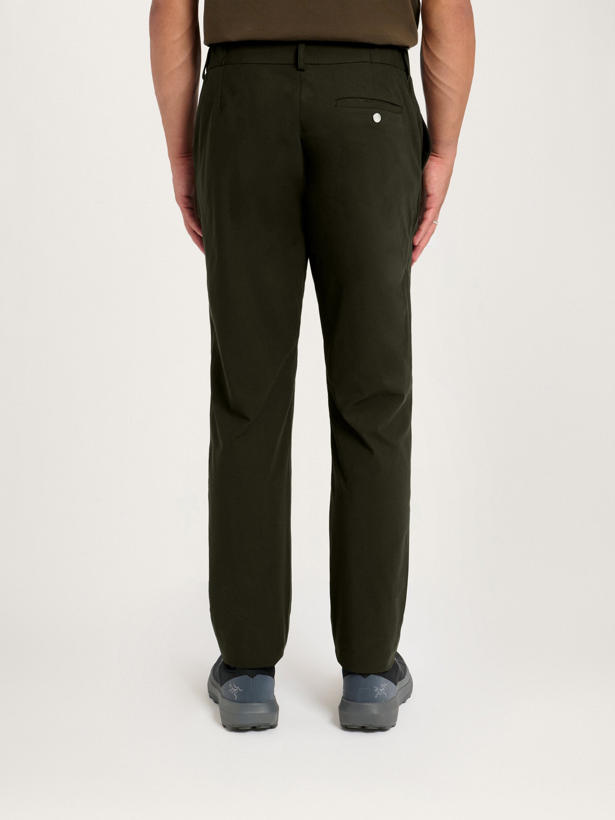 Rear view of a model wearing the Lestrange 360 Trouser in Dark Olive, showing the full-length fit and back pocket detail.