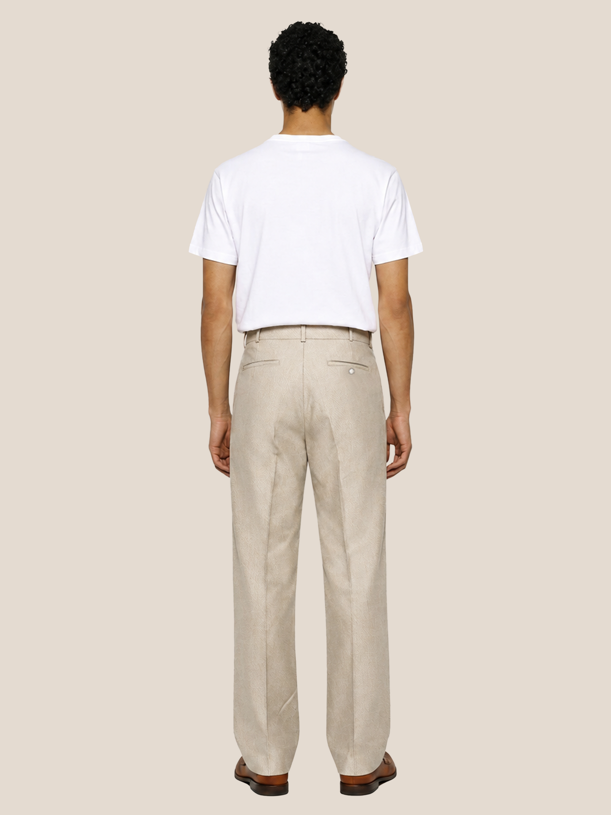 Back view of the LESTRANGE natural beige linen trousers, showing the straight-leg fit, belt loops and back welt pockets.