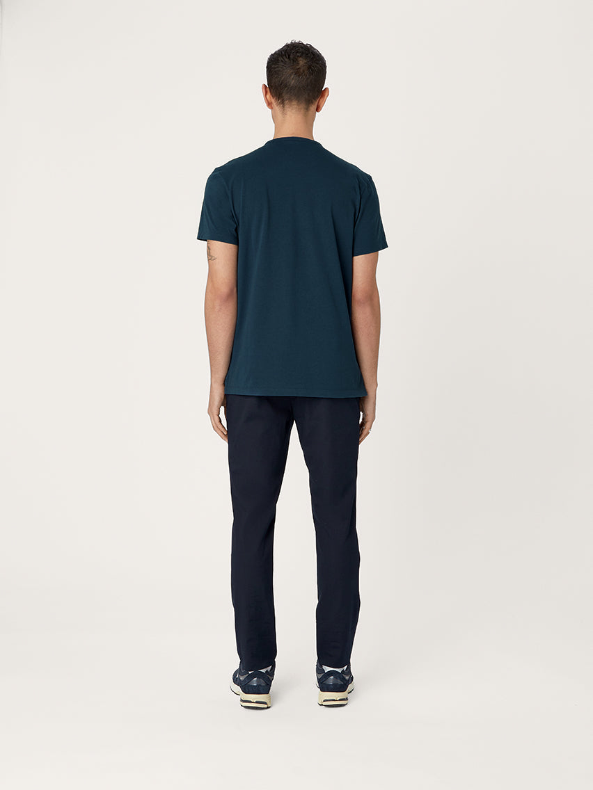Person wearing a dark blue t-shirt and pants on a white background