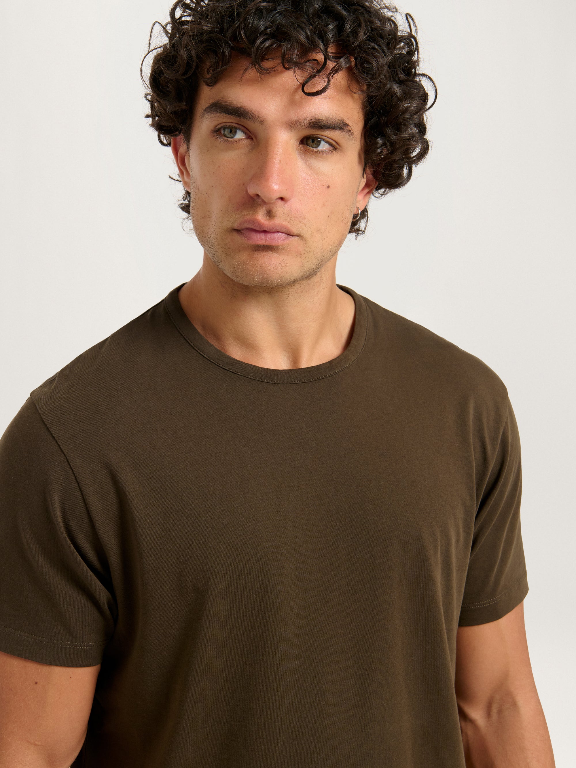 Close-up of Lestrange London Classic Tee in dark olive showing soft organic cotton fabric