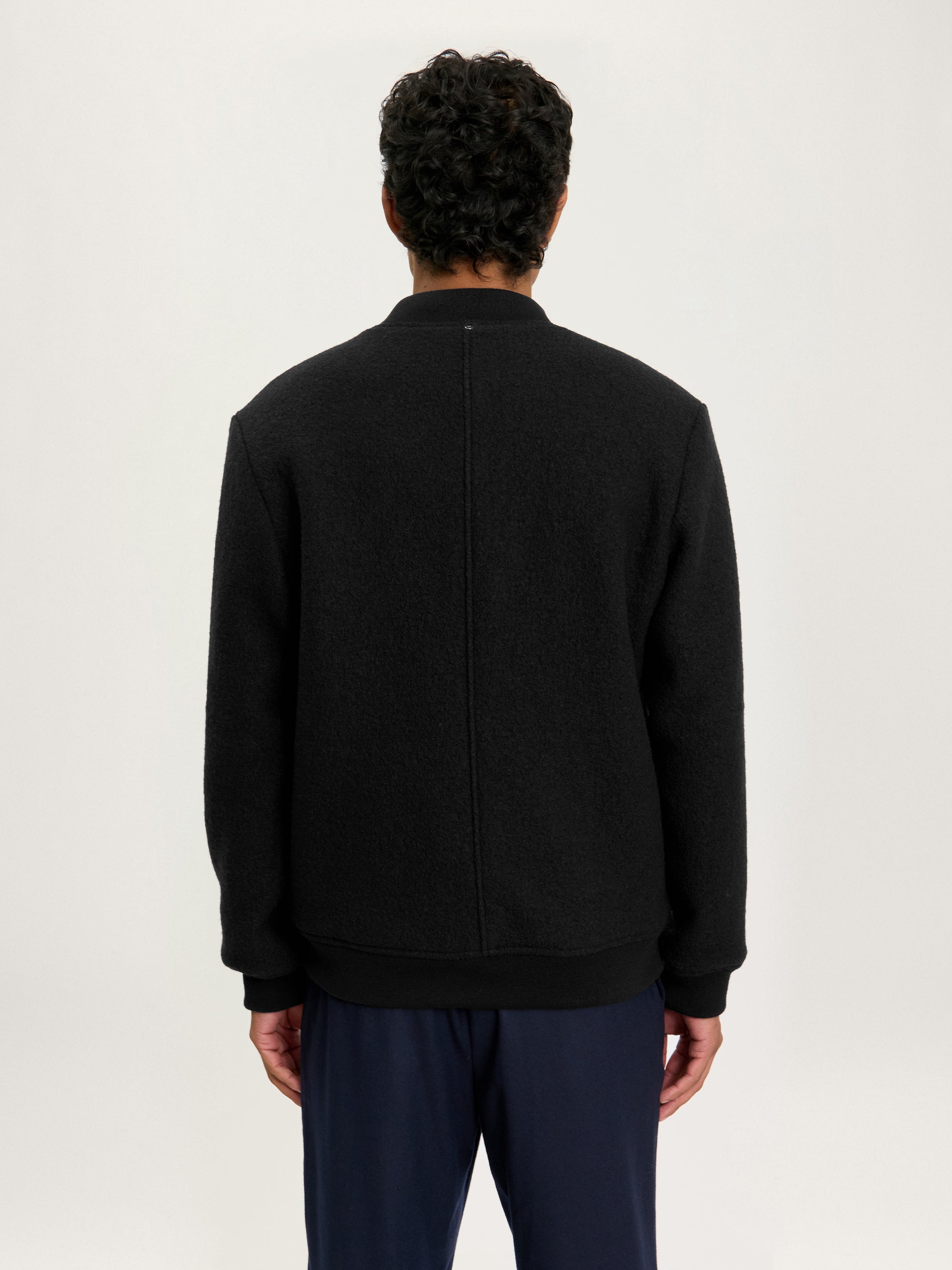 Back view of the Lestrange London Cloud Wool Bomber in black, highlighting clean seam and tailored silhouette.