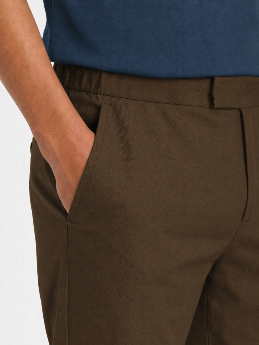 Close-up of LESTRANGE khaki trousers showing elasticated waistband, belt loops and side pocket detail