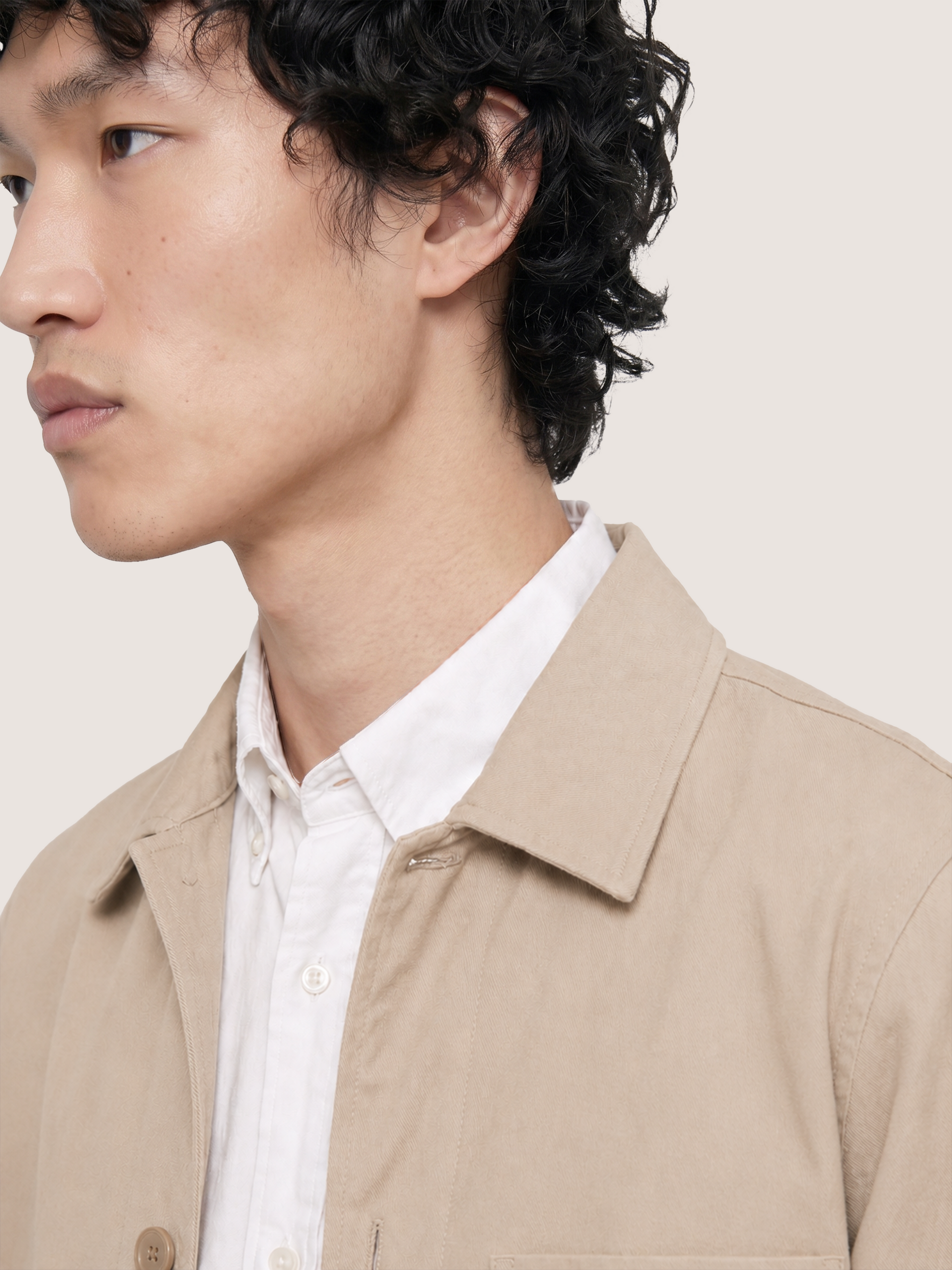 Close-up of the LESTRANGE beige overshirt collar, showing the soft textured fabric and button-front construction.
