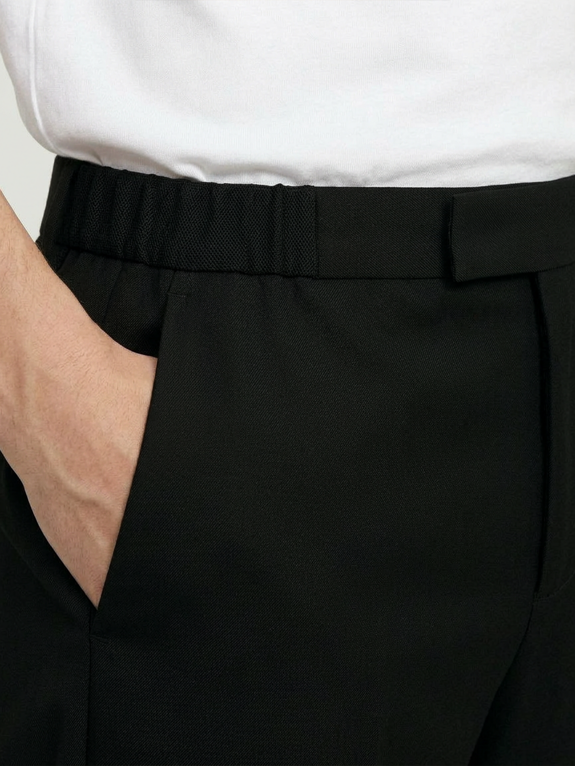 Close-up of the LESTRANGE black tropical wool trouser waistband, showing the textured fabric, belt loops and side pocket.
