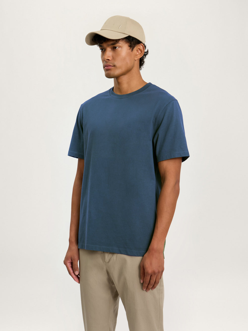 Model wearing Lestrange heavyweight cotton T-shirt in petrol blue with relaxed fit and crew neck