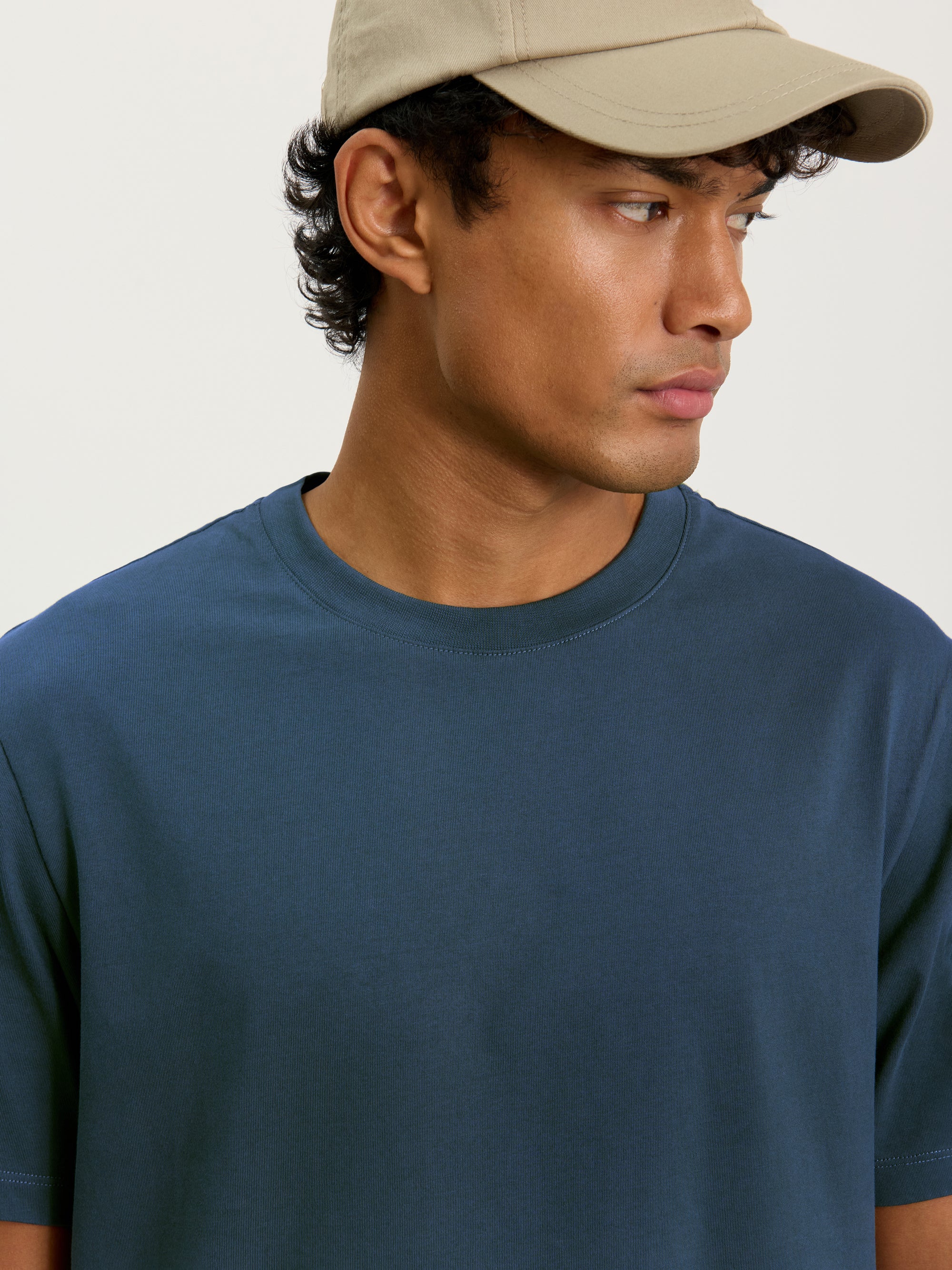 Close-up of Lestrange heavyweight cotton T-shirt in petrol blue showing ribbed crew neckline