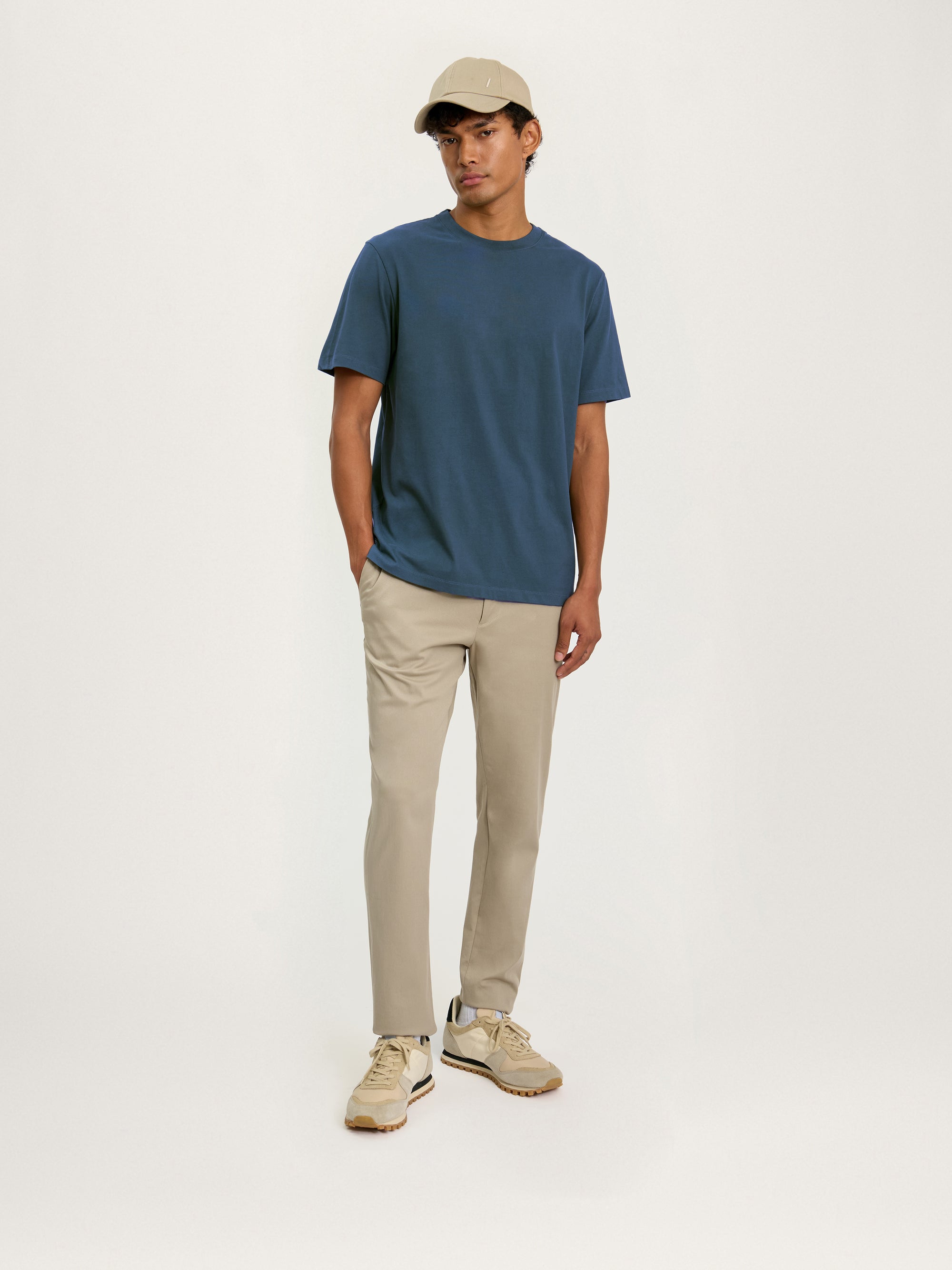 Lestrange heavyweight cotton T-shirt in petrol blue styled with beige trousers for everyday wear