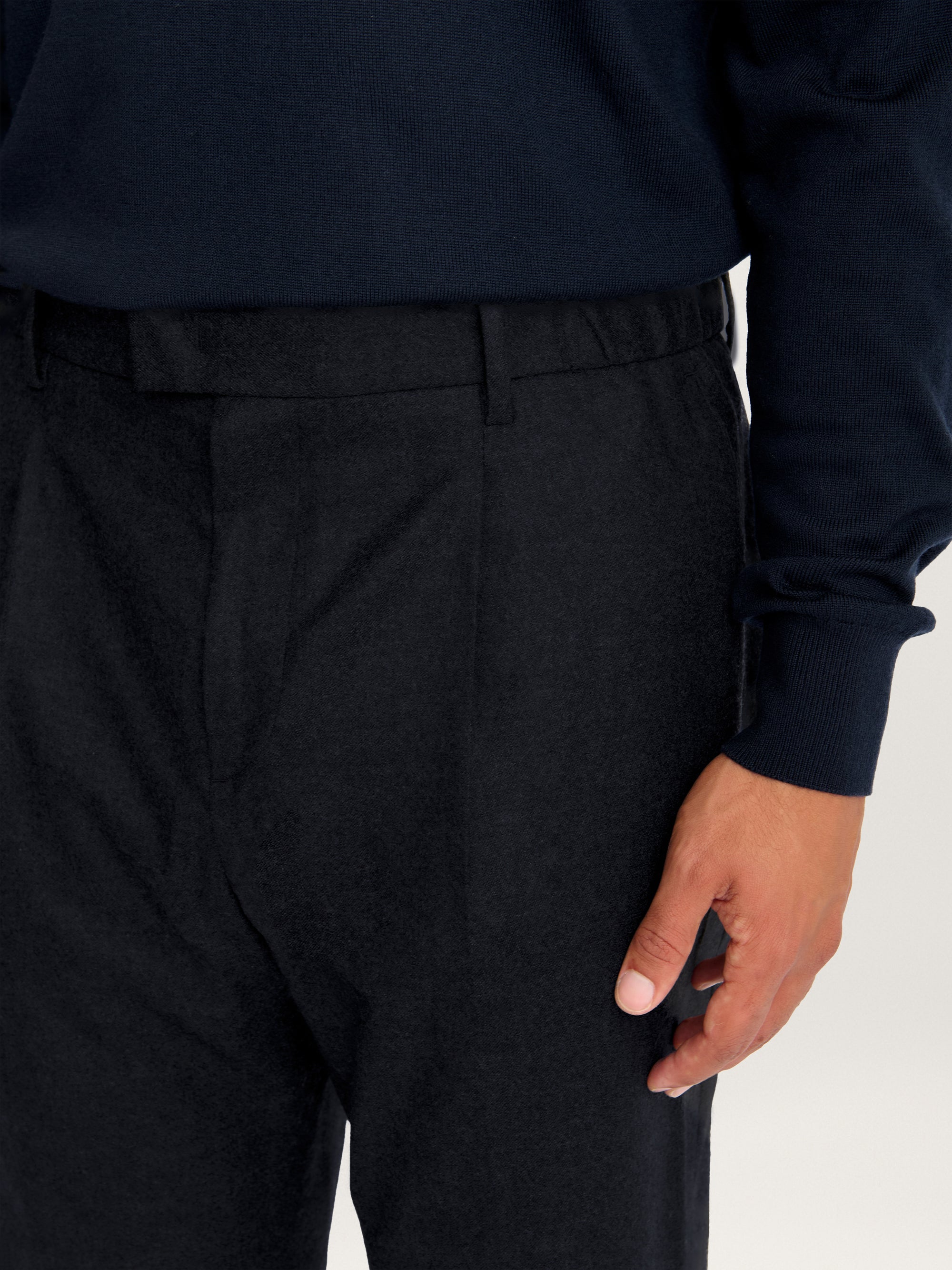 Close-up detail of Lestrange Pleated Wool Trousers waistband showing front pleats, belt loops, and fine wool texture in navy.