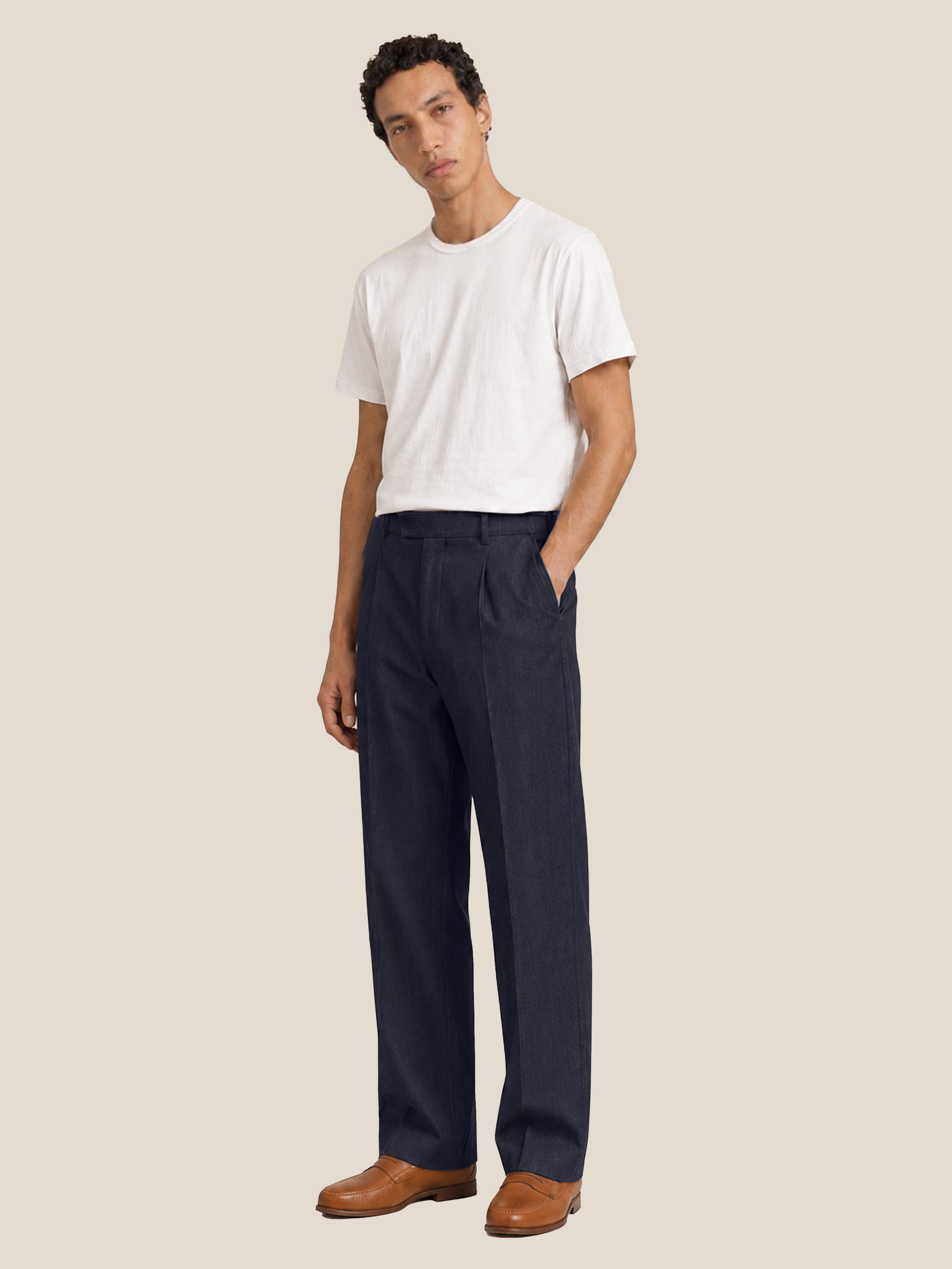 Side view of the LESTRANGE navy linen trousers, showing the relaxed straight-leg fit, front pleats and side pocket.