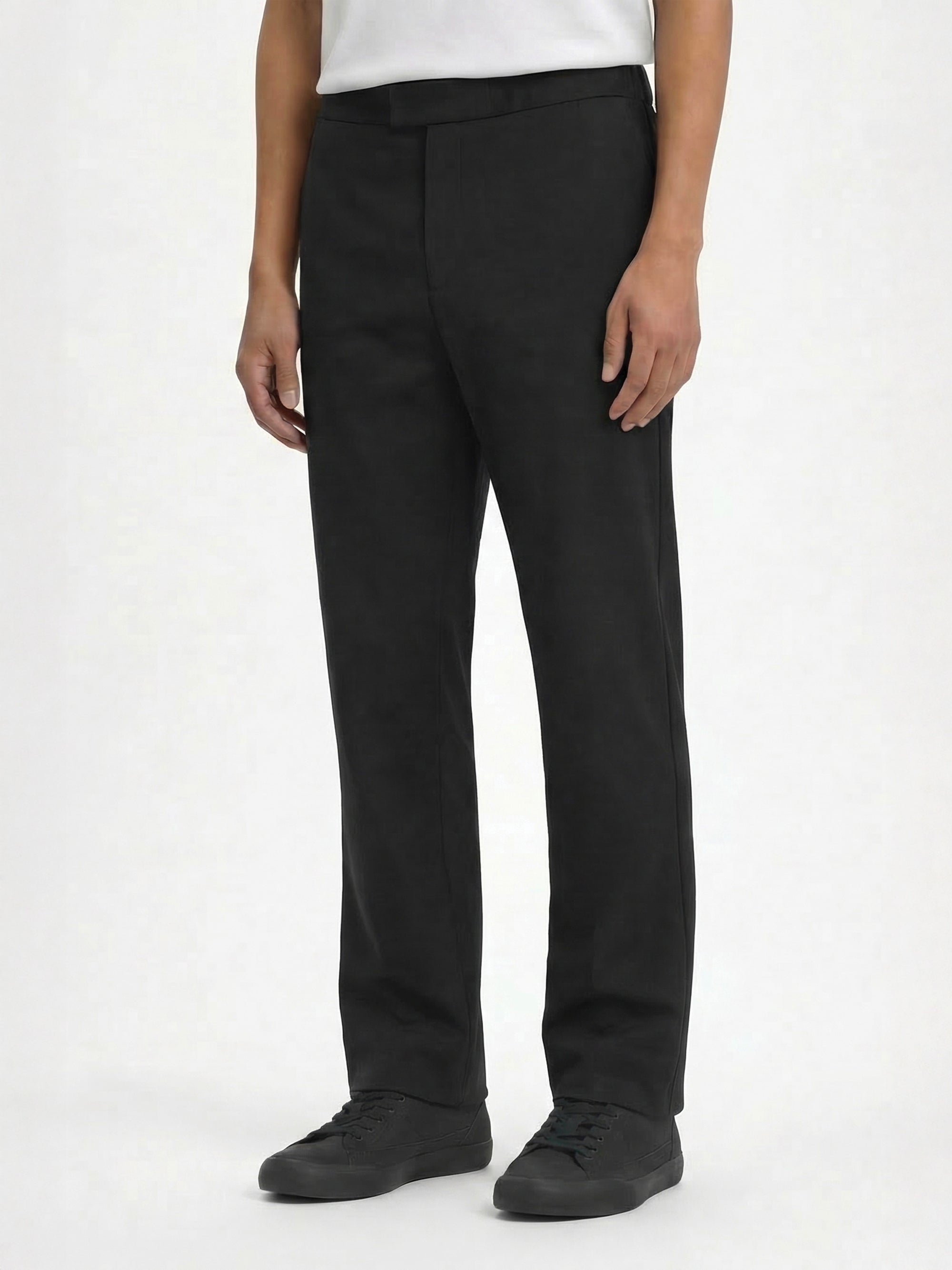 Side view of LESTRANGE black trousers, showing the tailored waistband, straight-leg fit, and minimal everyday design.