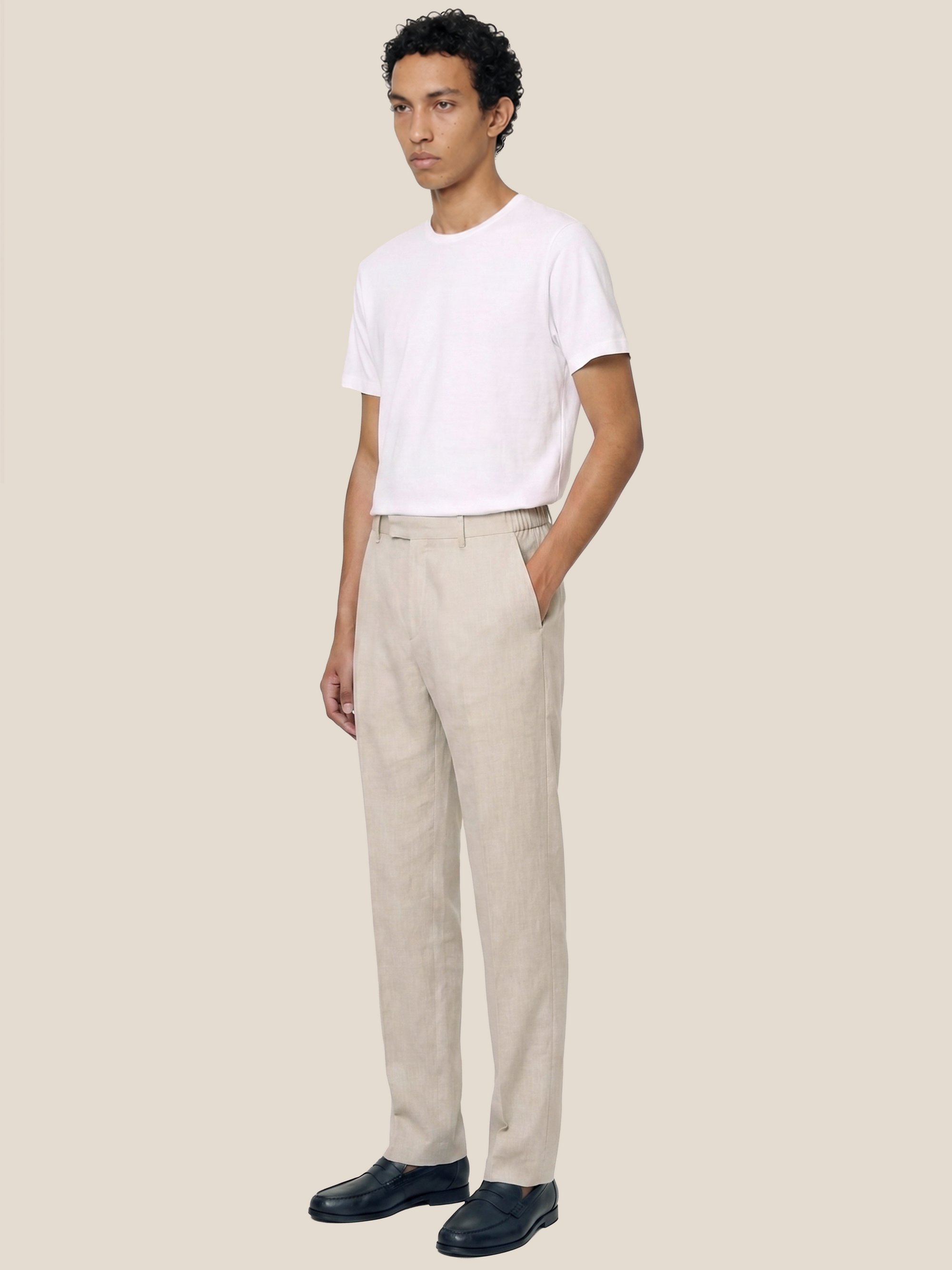 Side view of the LESTRANGE regular natural beige linen trousers, showing the clean regular fit, side pocket and tailored leg shape.