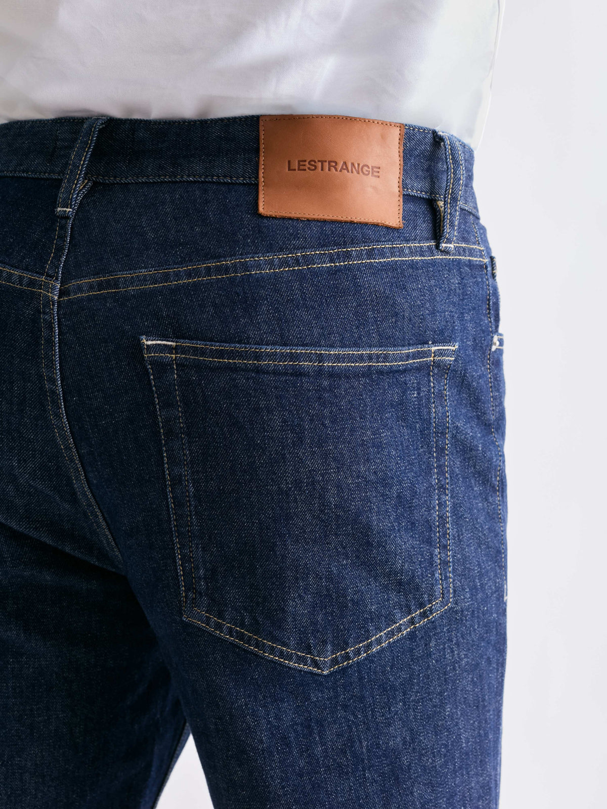 The 24 Jeans Straight Fit in Dark Blue, close-up of back pocket, stitching and LESTRANGE leather patch