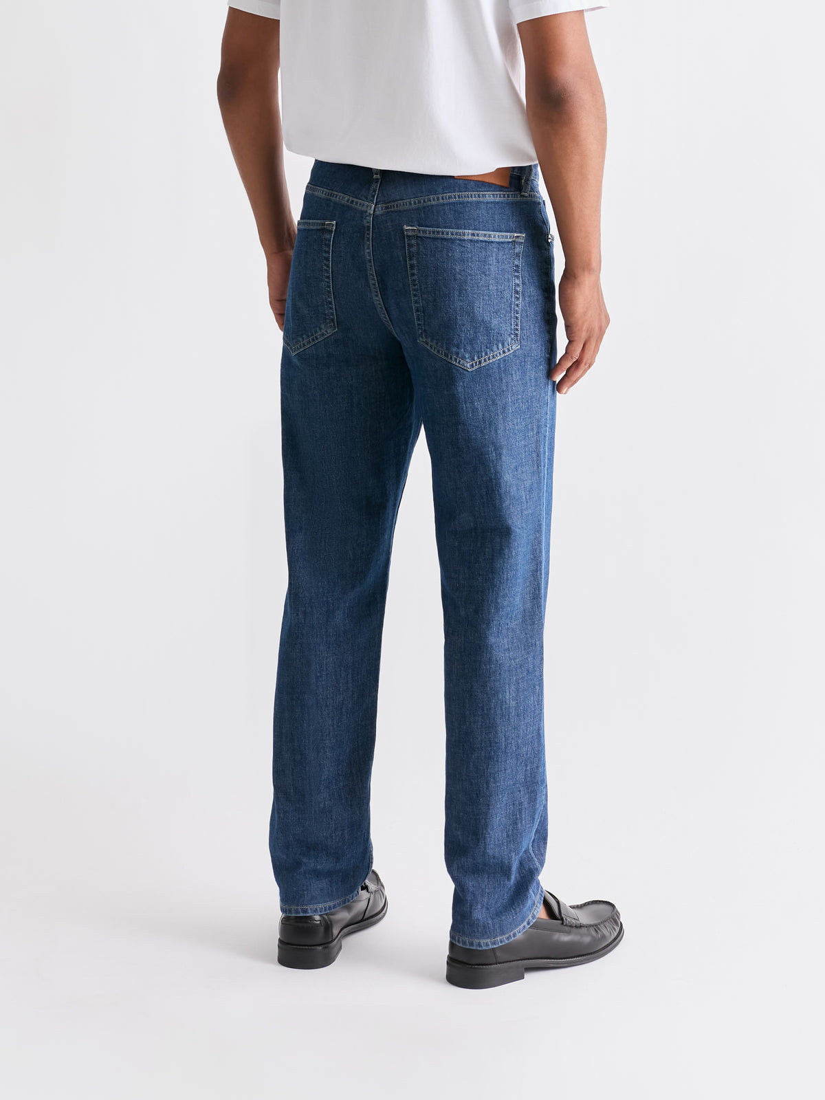 The 24 Jeans Straight Fit in Mid Blue, rear view showing back pockets and straight-leg silhouette